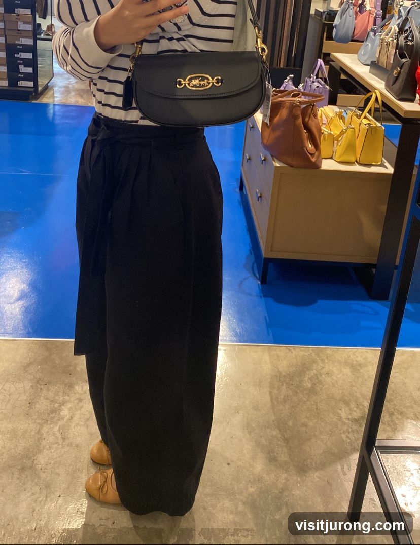 Woman holding a black handbag
