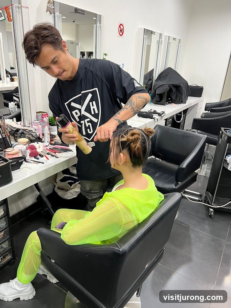 Hairdresser styling client's hair