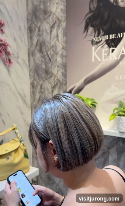 Woman looking at phone in salon