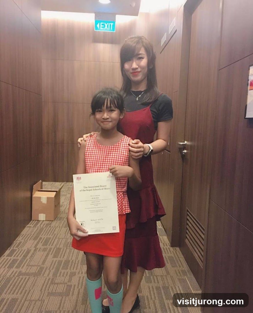 Two people posing with a certificate