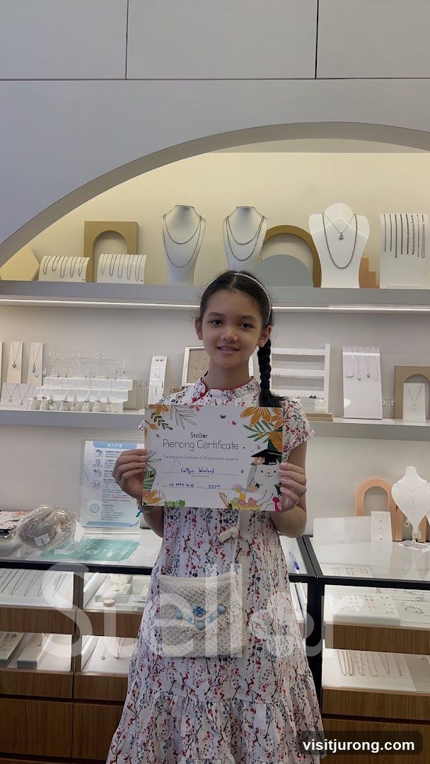 Girl holding a piercing certificate