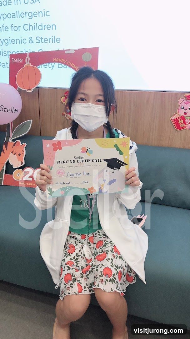 Girl Holding Piercing Certificate