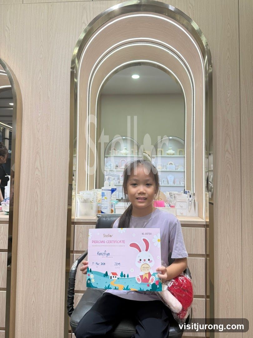 Girl holding a piercing certificate