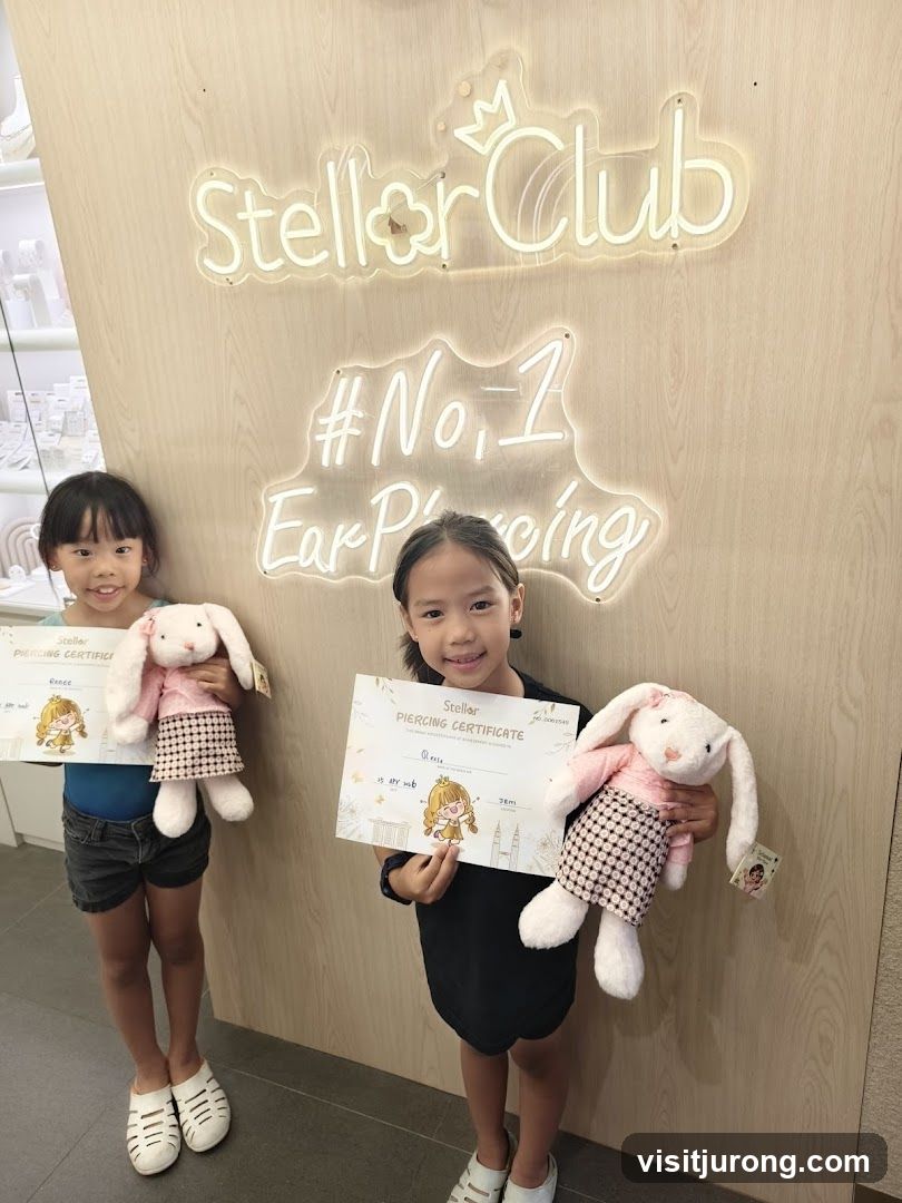 Two girls holding certificates and stuffed bunnies