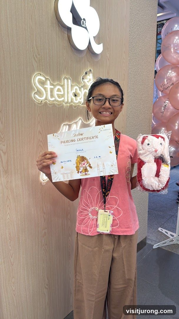 Girl Holding Piercing Certificate and Stuffed Toy