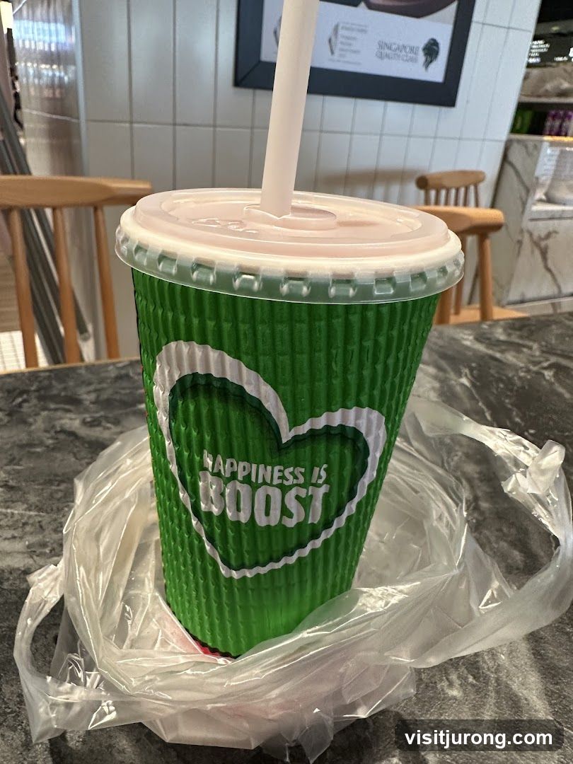 Green cup with "Happiness is Boost" logo