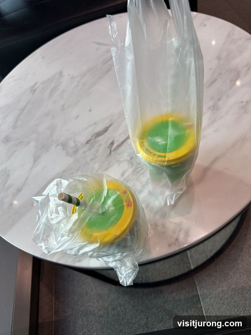 Two drinks in plastic bags on a table