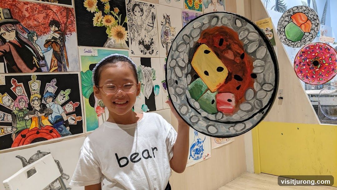Child holding a painting of sushi