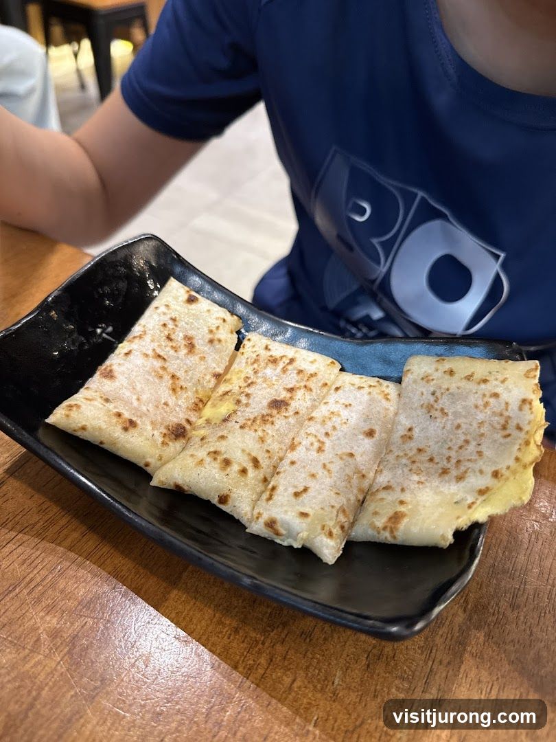 Rolled Crepes on a Black Plate