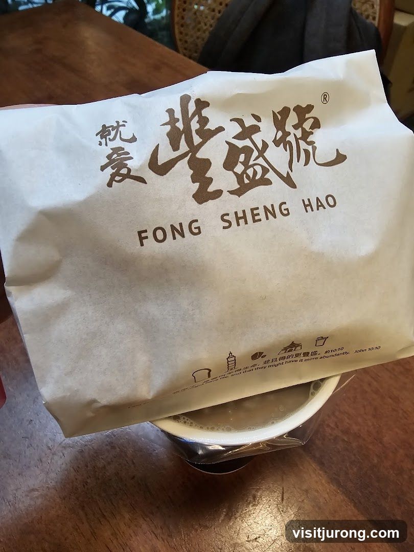 Paper bag with logo and text over a cup