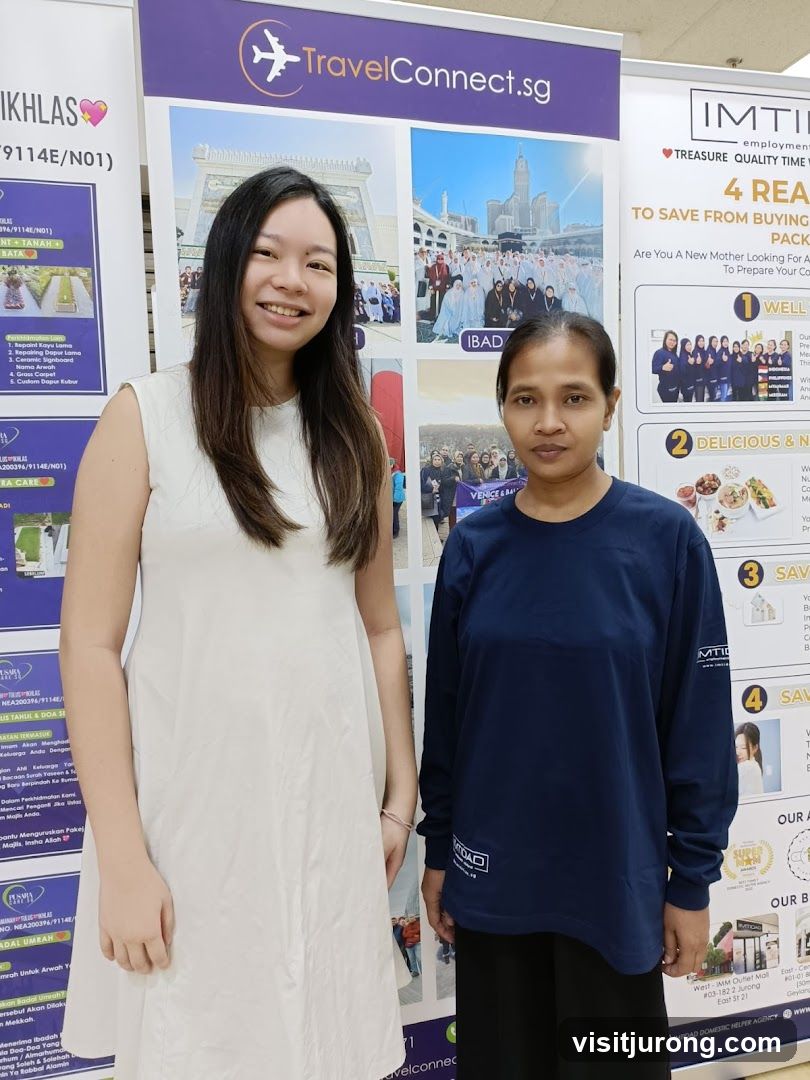 Two women standing in front of promotional banners