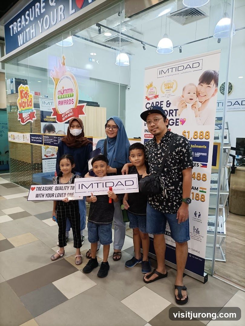 Family posing with IMTIDAD banner