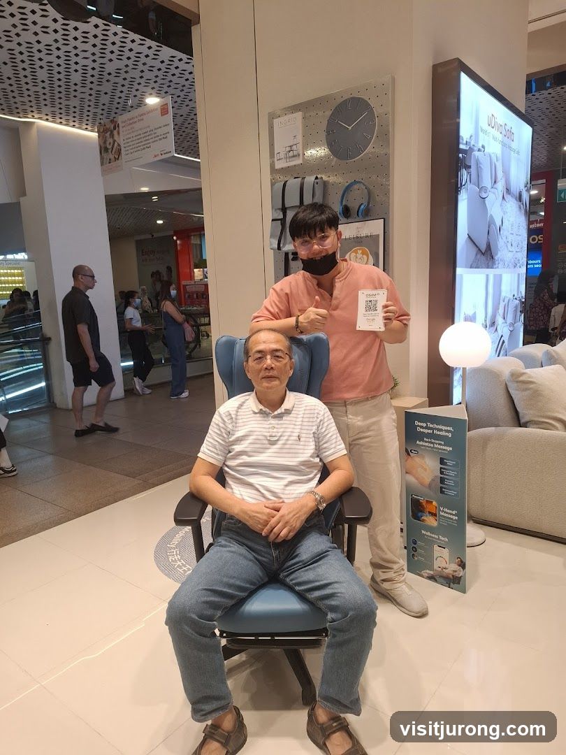 Man sitting in massage chair with staff
