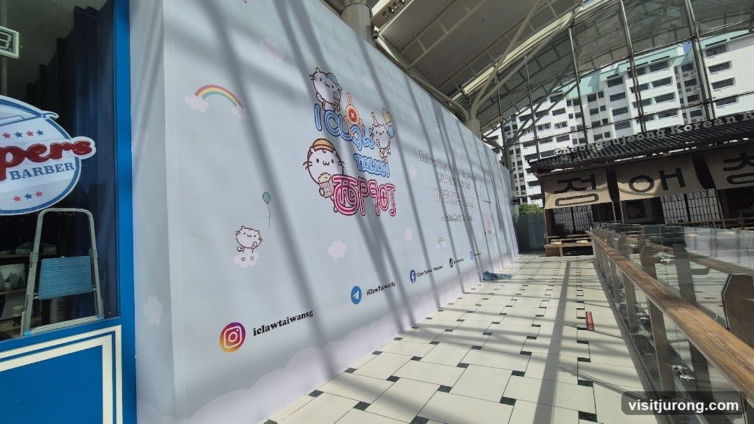 Temporary construction hoarding with cartoon characters and social media handles
