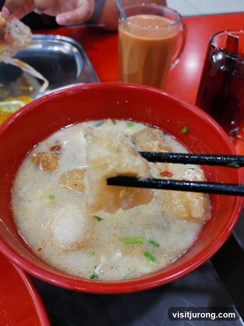 Bowl of Soup with Fried Dough and Fish Balls