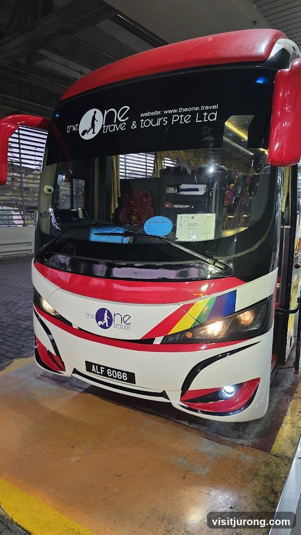 Bus with "The One Travel & Tours" Branding