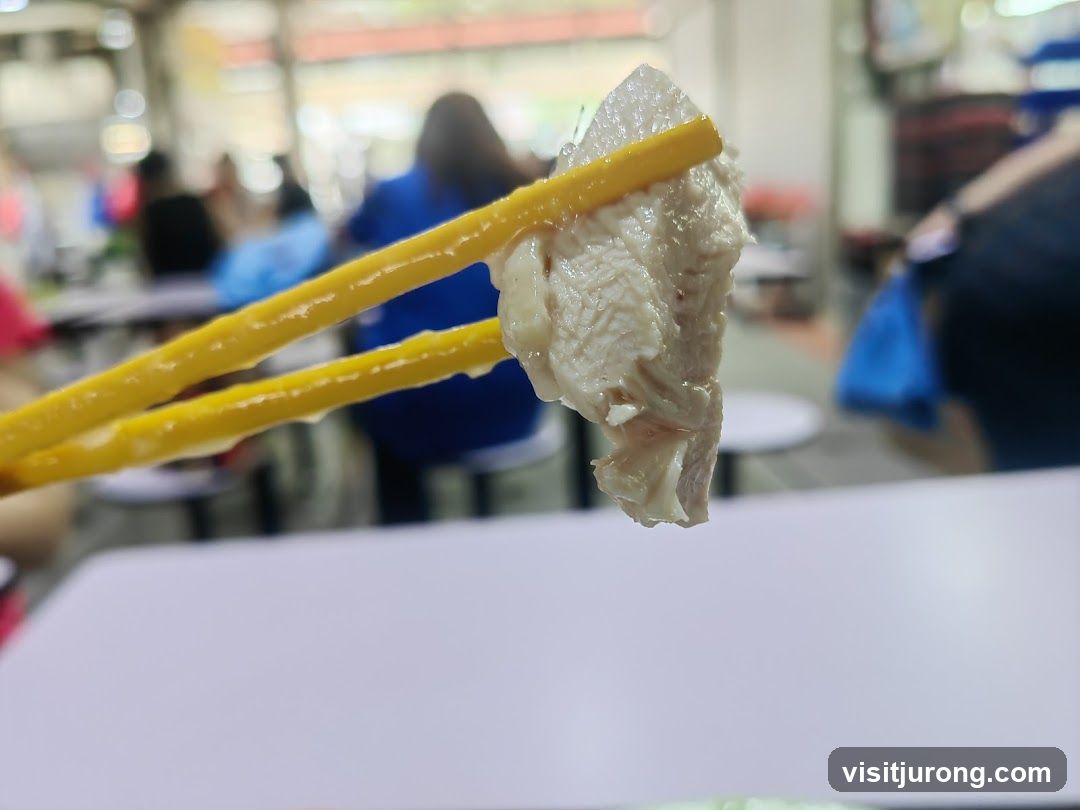Chicken being held by chopsticks