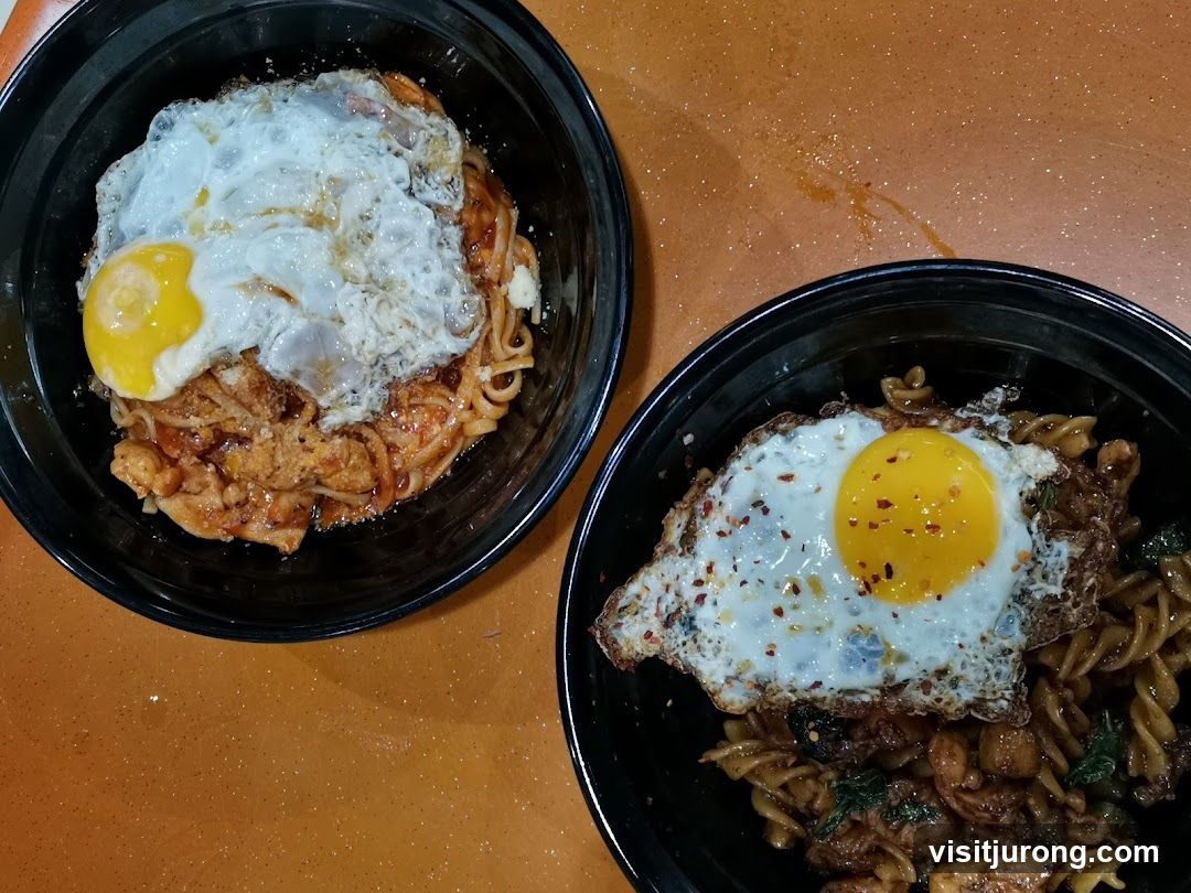 Two bowls of noodles with fried eggs