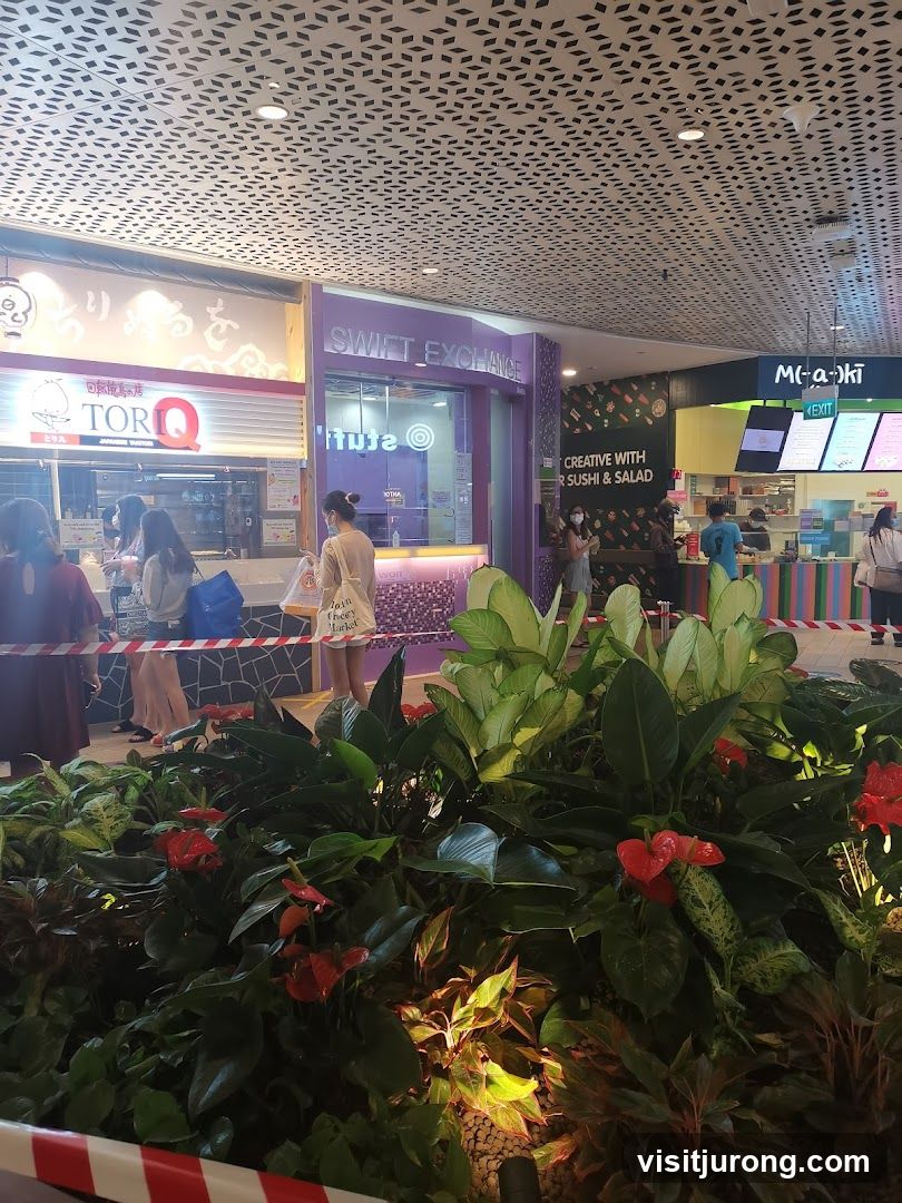 Food court with various stalls and plants