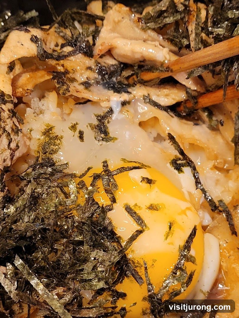 Close-up of a rice bowl with egg and seaweed