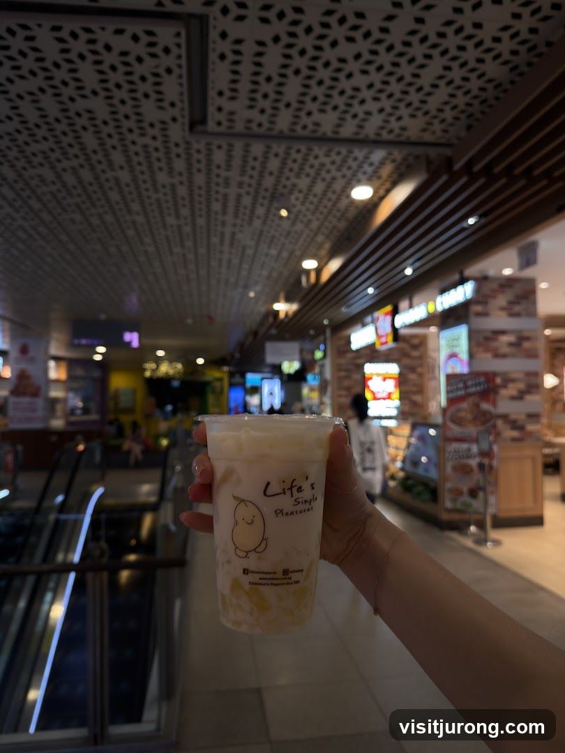 Hand holding a drink with logo