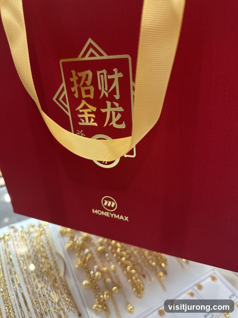 Red gift bag with gold lettering and logo
