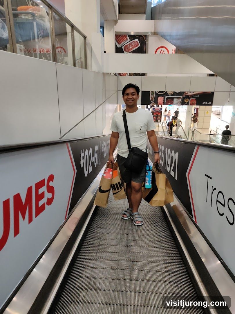 Man on Escalator with Shopping Bags
