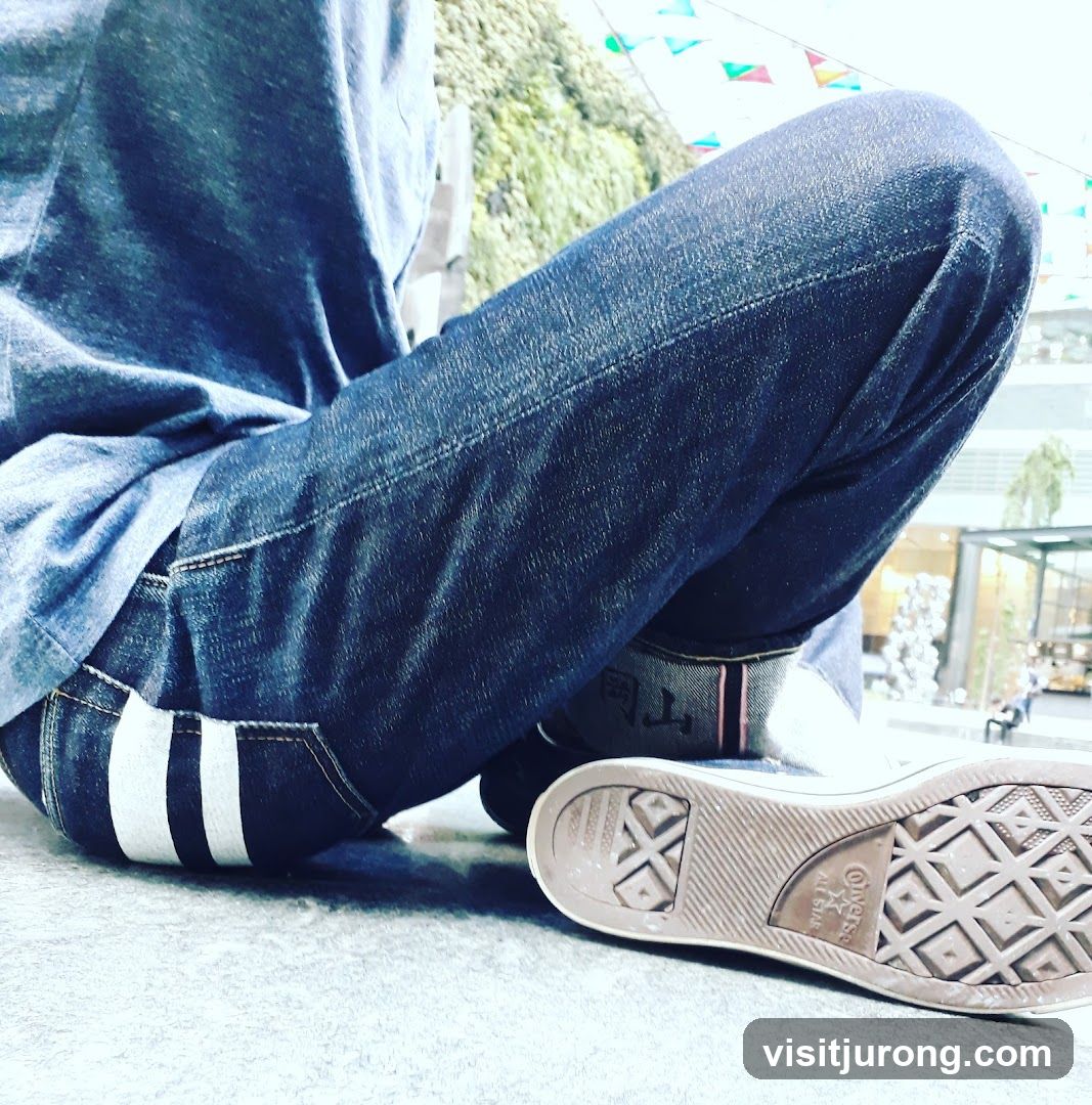 Person in Jeans and Sneakers