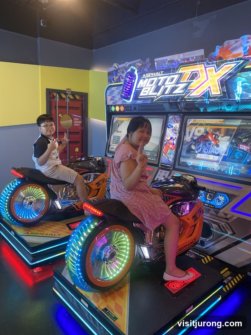 Children playing motorcycle arcade game