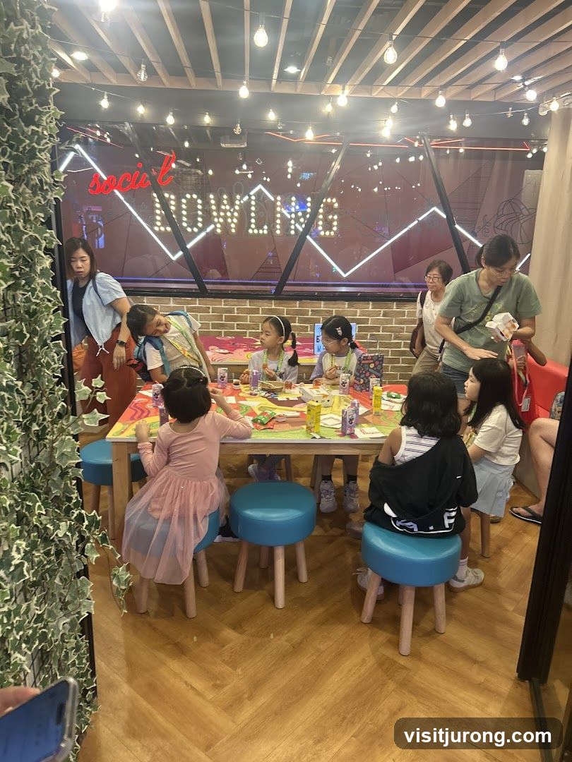 Children at a table with a neon sign in the background