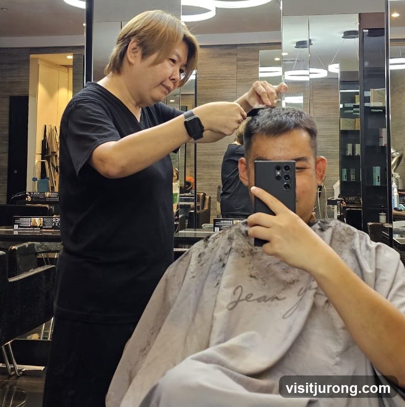 Hairdresser cutting client's hair