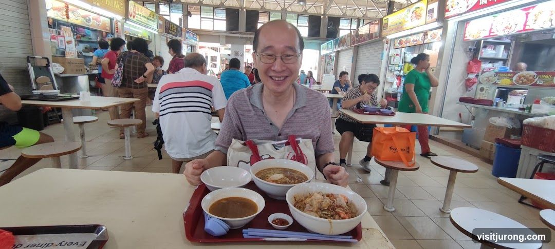 Man Enjoying Food at a Hawker Center