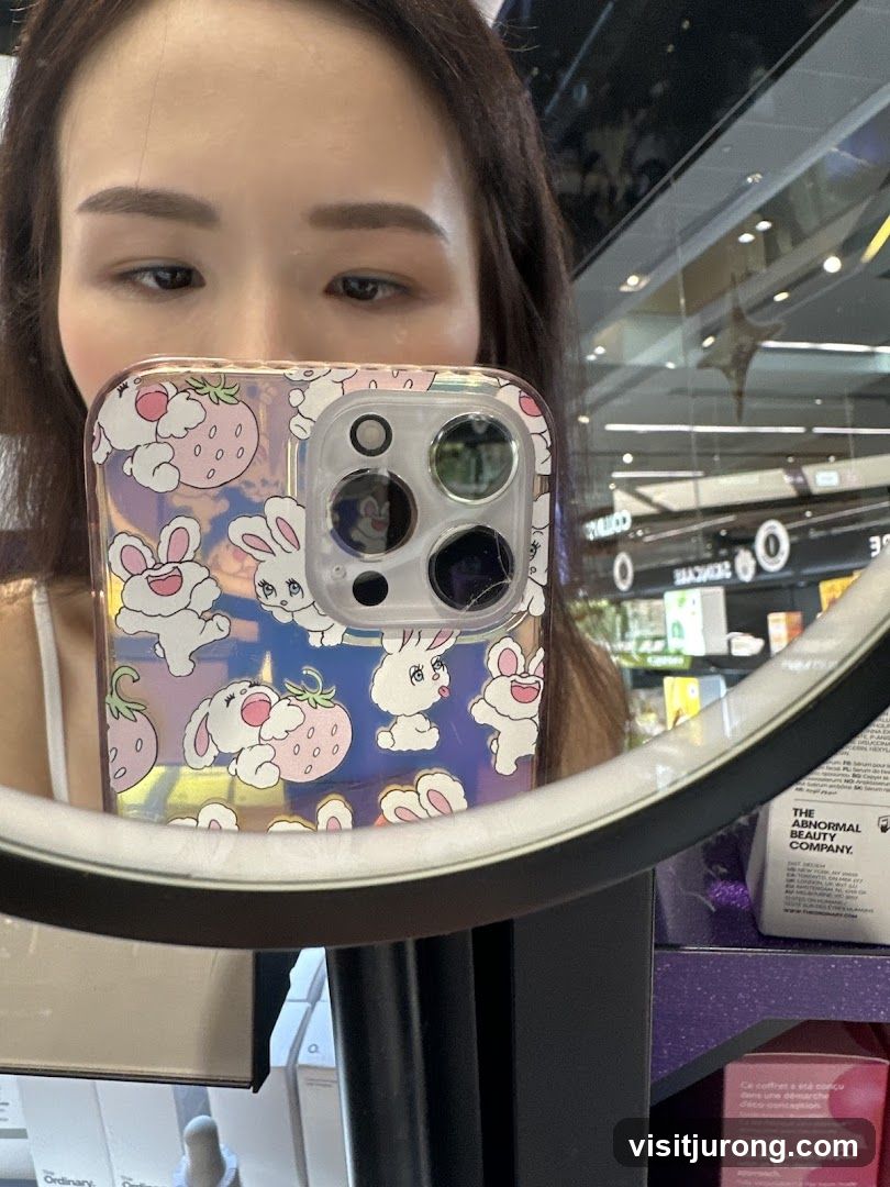 Woman holding phone with bunny and strawberry case