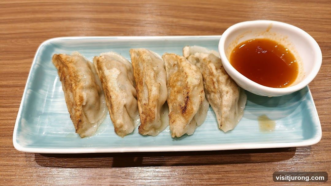 Pan-fried dumplings with dipping sauce