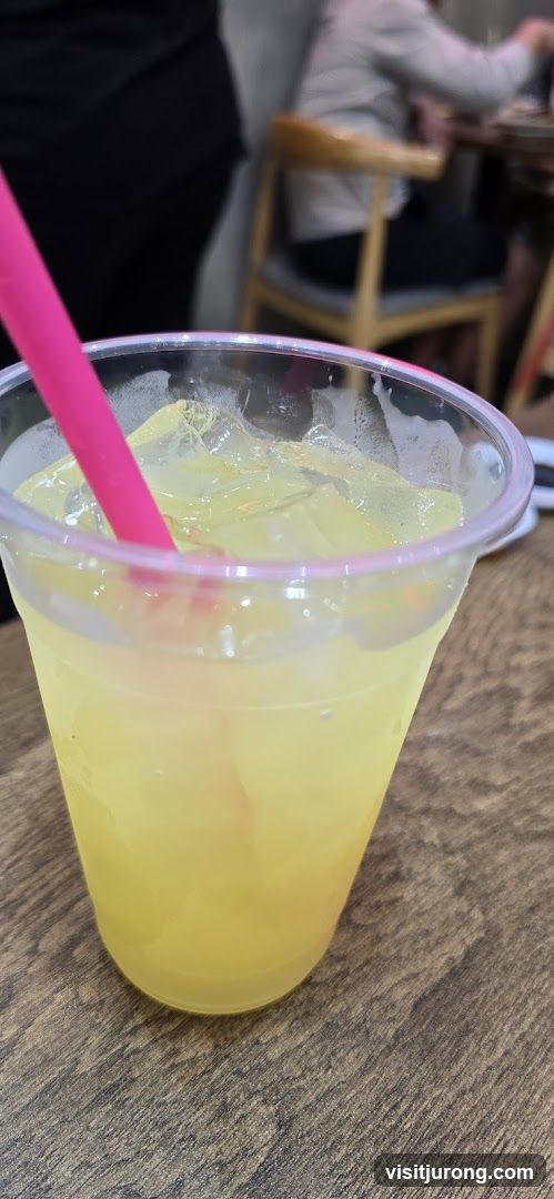 Yellow Drink with Ice and Pink Straw