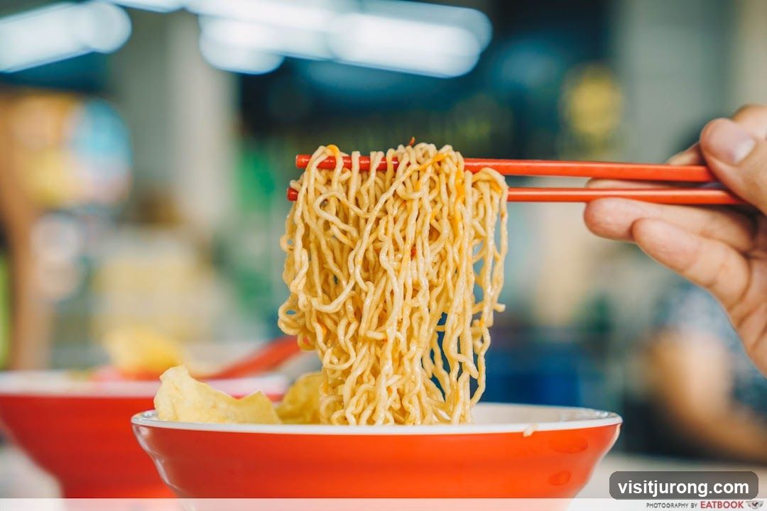 Noodles being lifted with chopsticks
