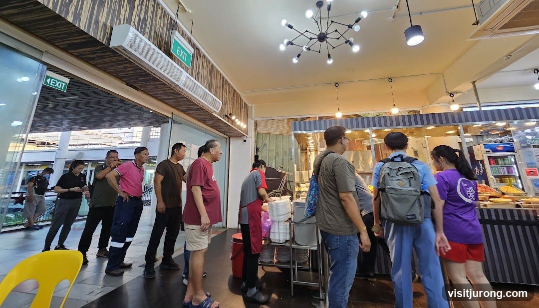 People queuing at a food stall