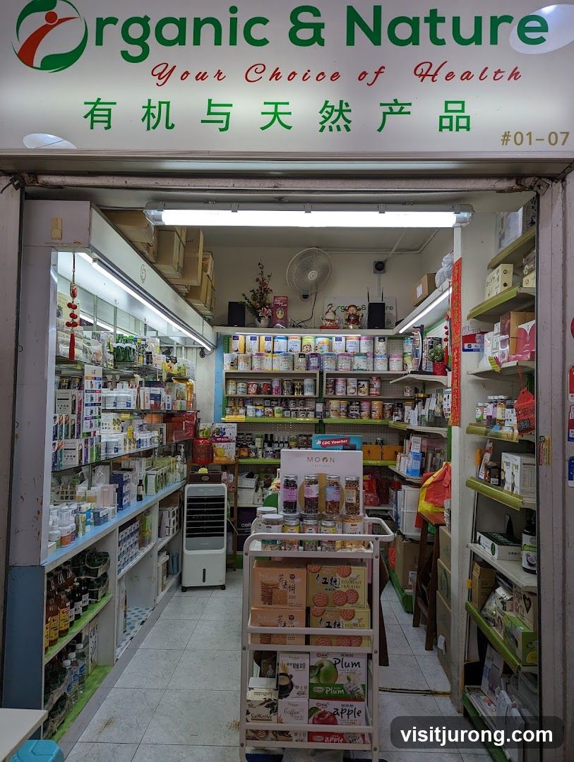 A storefront for a health food store named Organic & Nature, with products displayed on shelves and a cart. The store's name and slogan are visible above the entrance.
