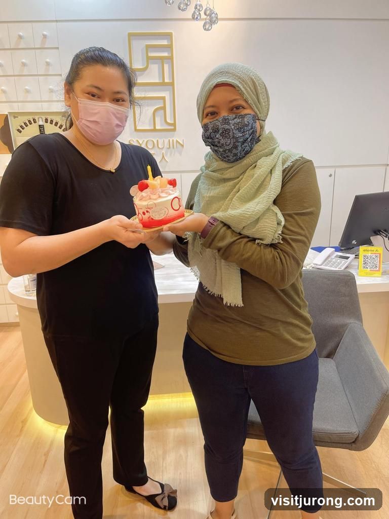 Two women holding a cake