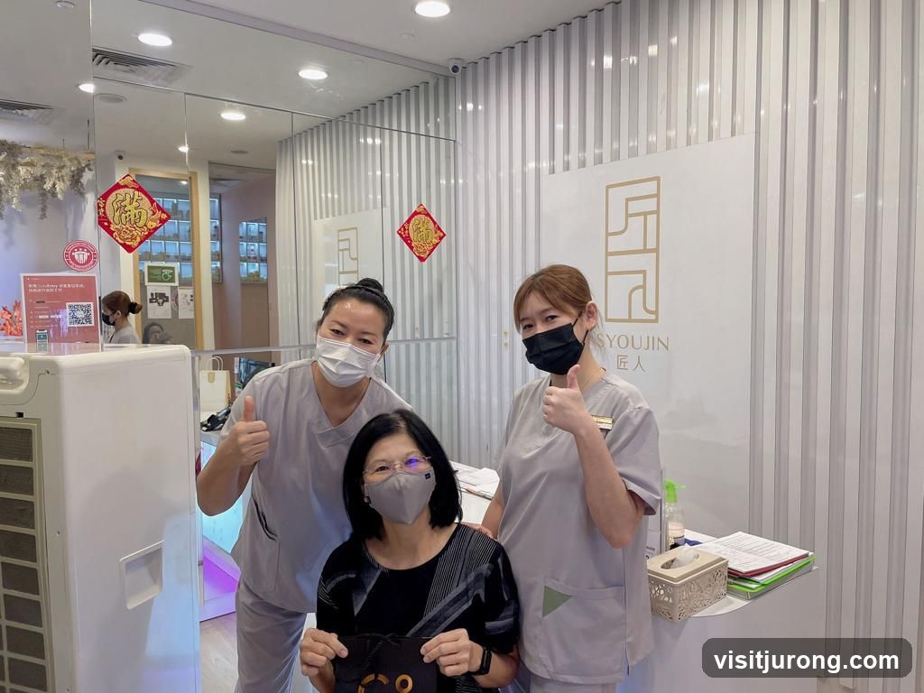 Two staff members give thumbs up to a customer