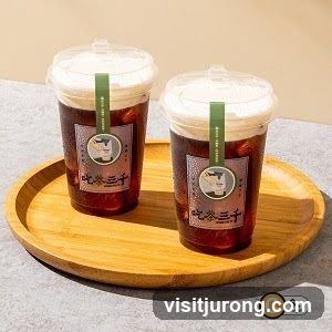 Two drinks on a wooden tray