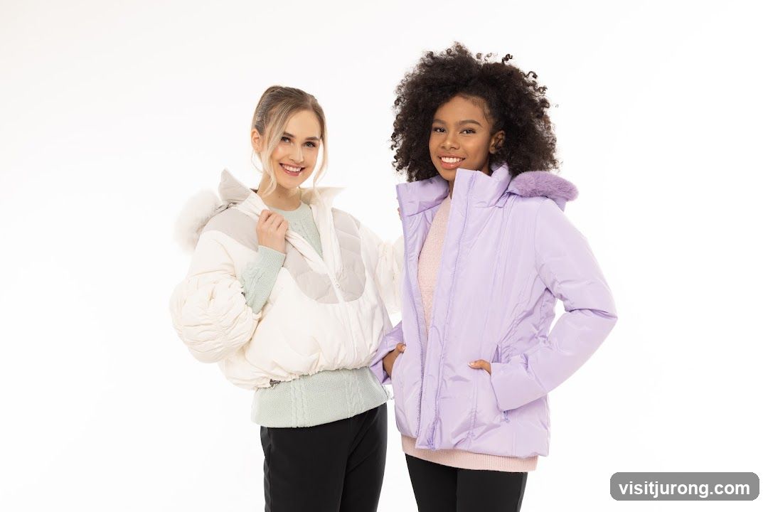 Two young women wearing puffer jackets